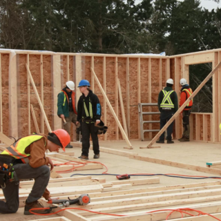 Carpentry students working working on a housing construction site.