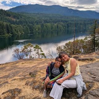 Two people with a lake view behind them