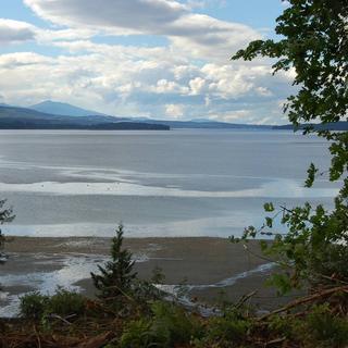 A view of Baynes Sound on a sunny day with some clouds in the sky