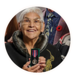 Smiling woman holding up a medal.