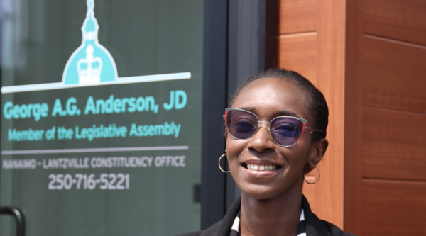 Awula standing outside George Anderson's office and smiling at the camera.