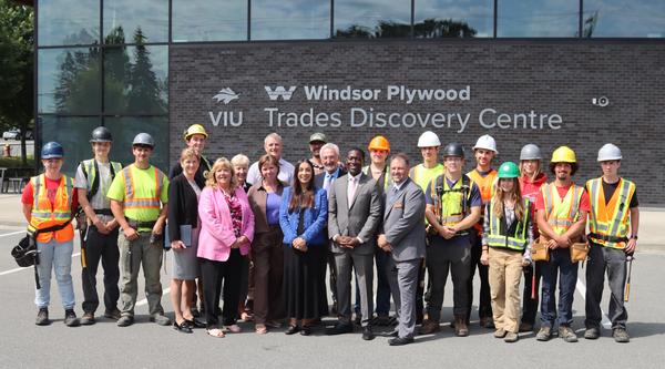A group of students staff and politicians standing in front of the VIU Trades Discovery centre