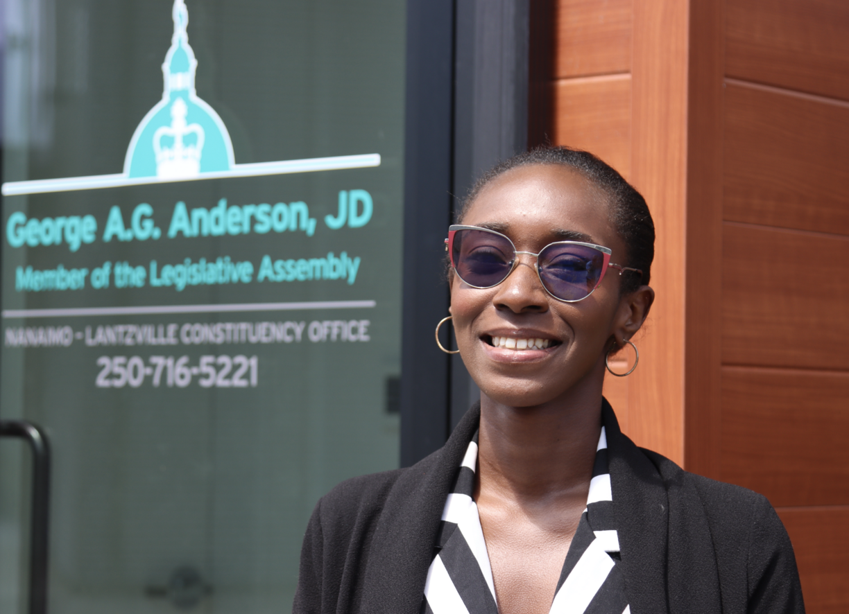 Awula standing outside George Anderson's office and smiling at the camera.