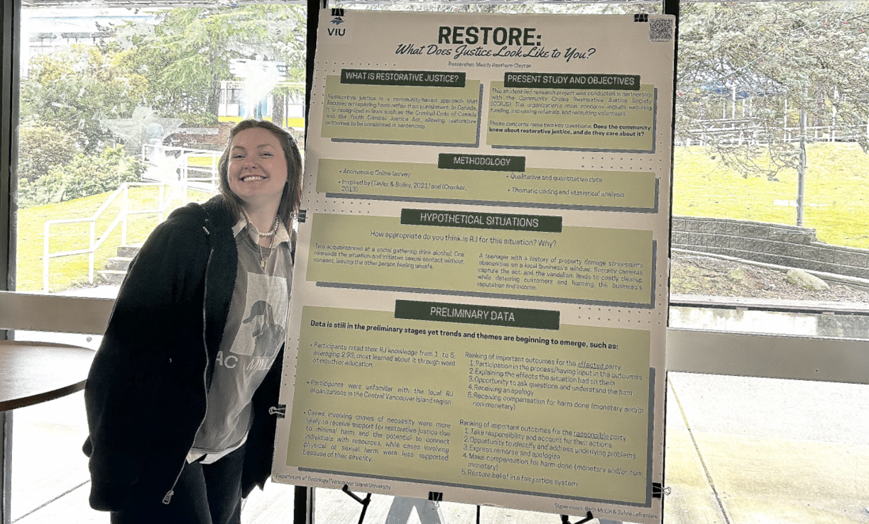 Madelyn in the cafeteria with her research poster