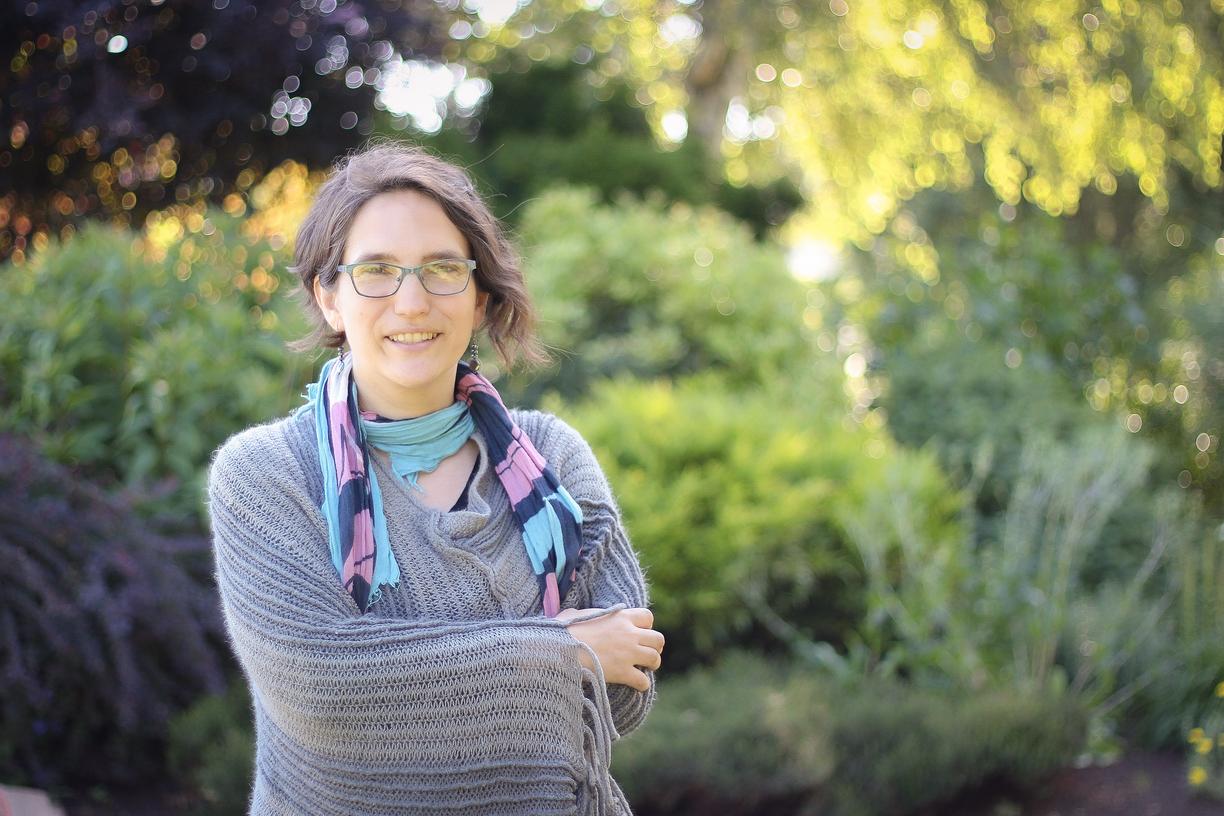 Sharon Karsten standing outside on a sunny day and smiling at the camera.
